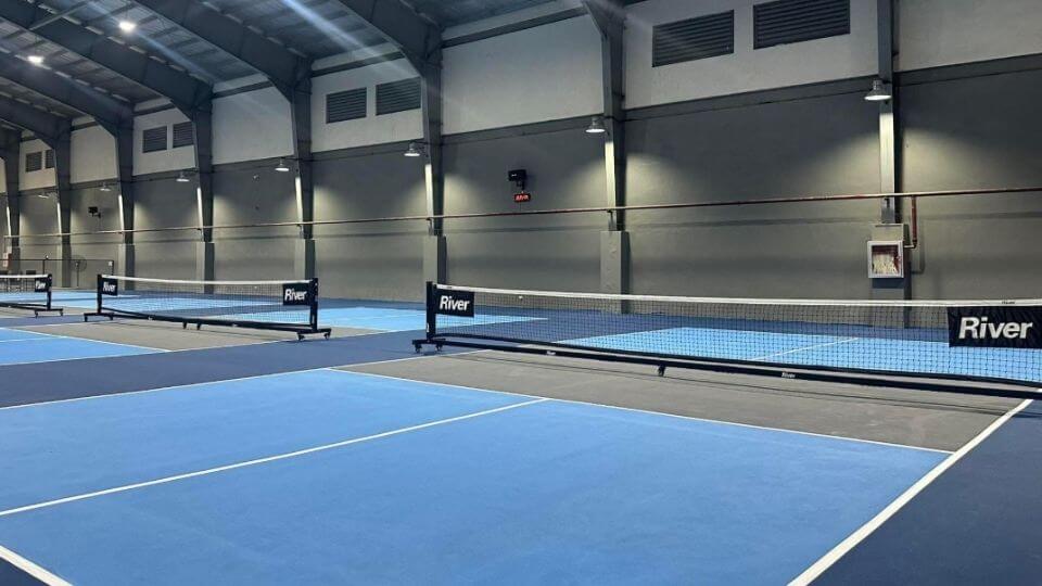Match Point Consolacion pickle ball courts with river branded nets
